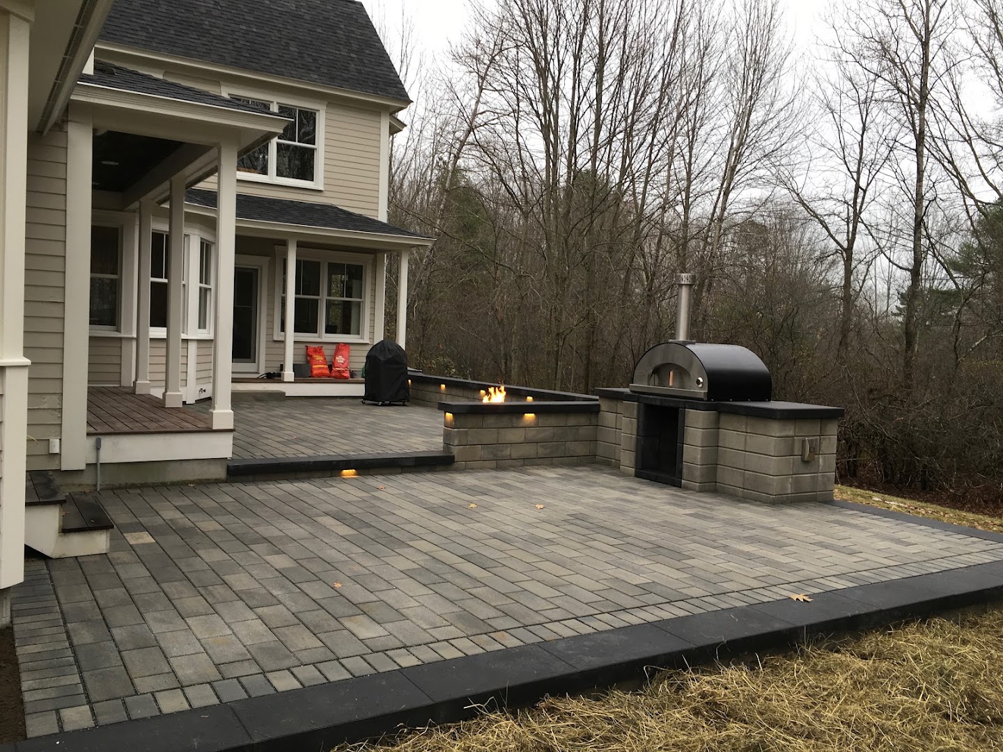 Paver patio with firepit and pizza oven